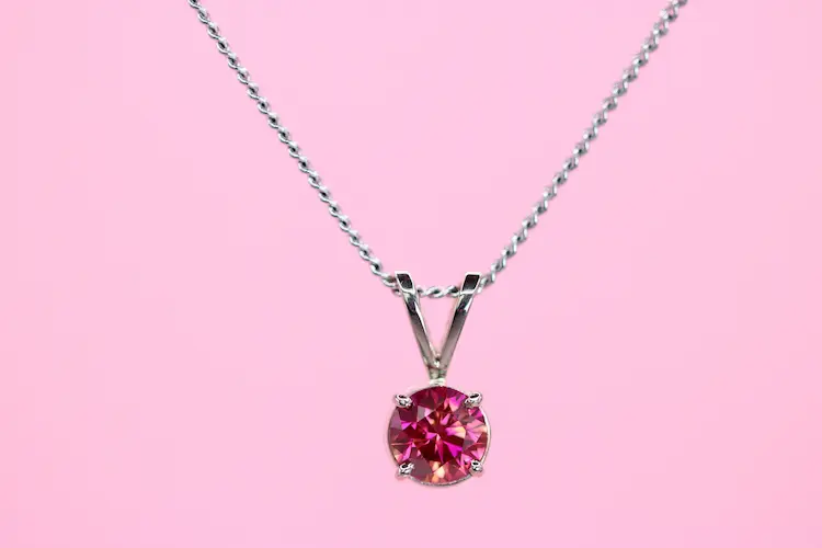 A pink memorial diamond, set in a pendant.