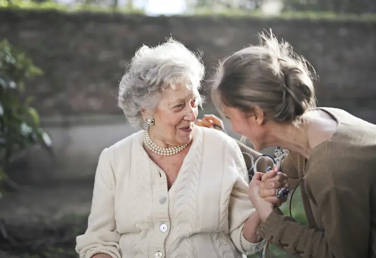 A woman, talking with her grandmother.