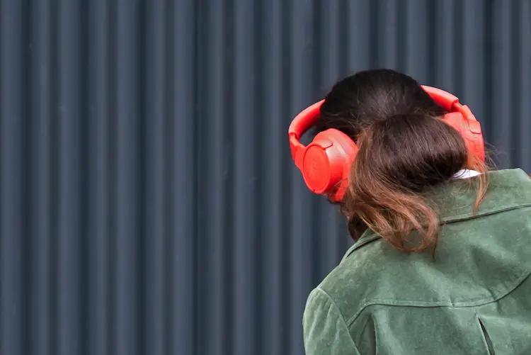 Woman, listening to music on her headphones.