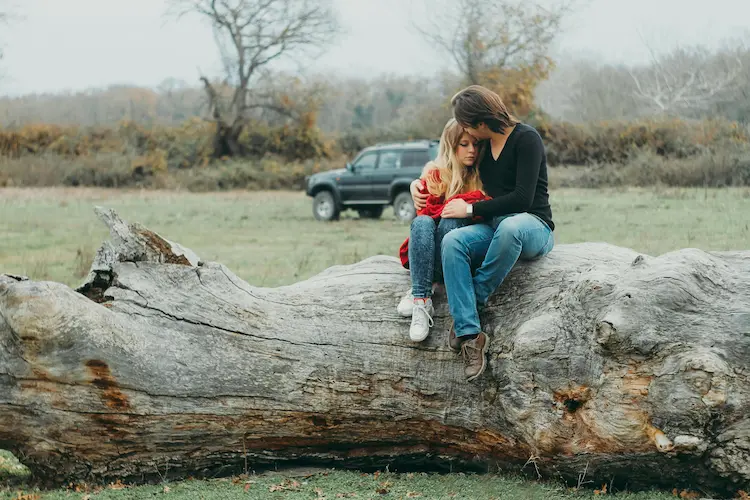 Mom, hugging her daughter.