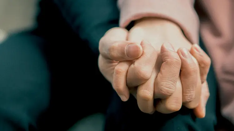 Two people holding hands.