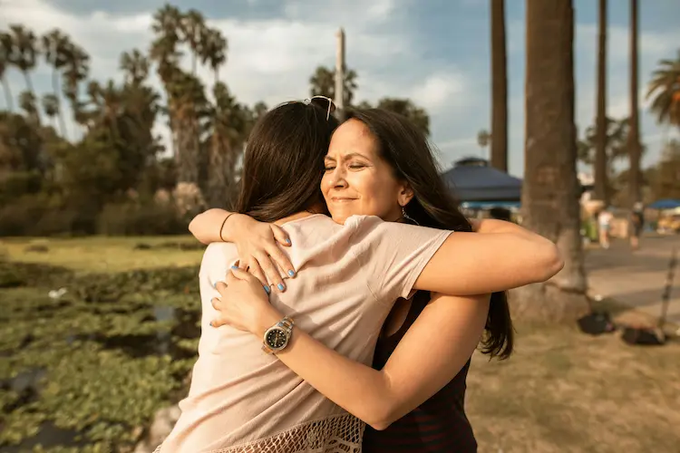 Two women hugging.