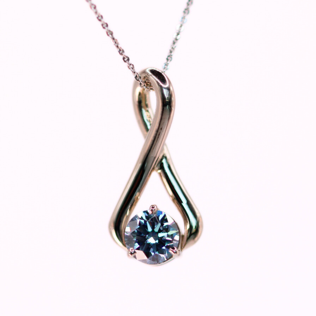 Blue round memorial diamond set in a white gold pendant.