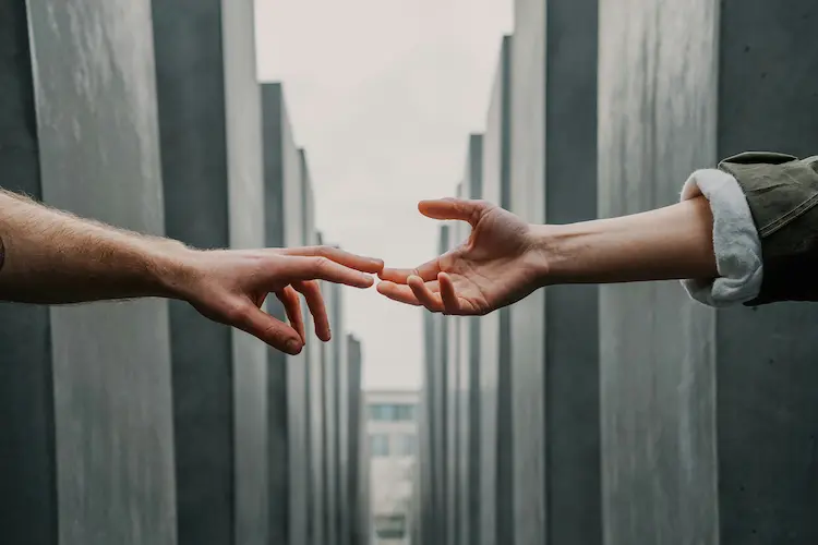 Two hands, reaching for each other.