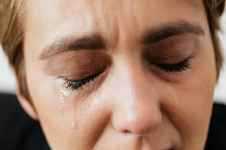 A woman, crying.