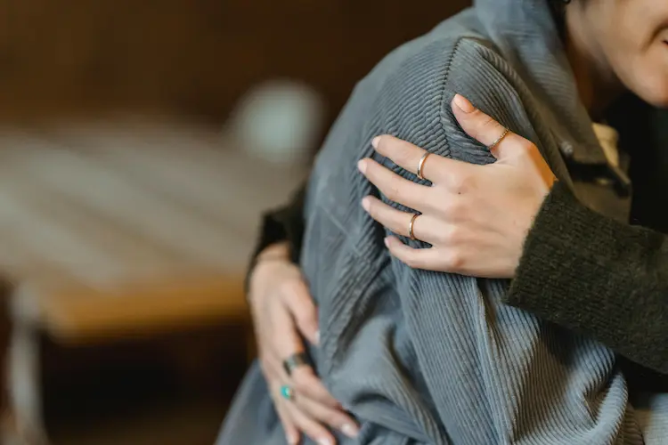 Two woman hugging.