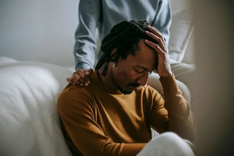 A woman, comforting a man.