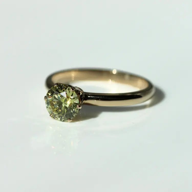 Yellow memorial diamond set in a yellow gold ring.