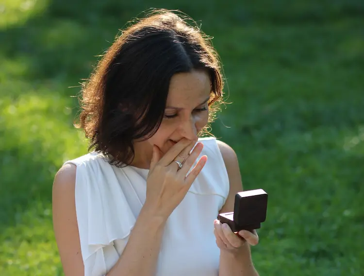 A woman opening a ring box.