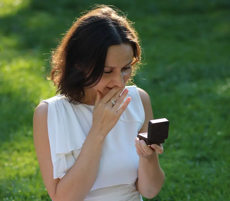 A woman opening a ring box.