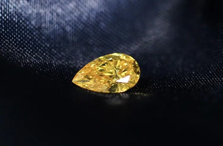 Yellow pear cut memorial diamond.