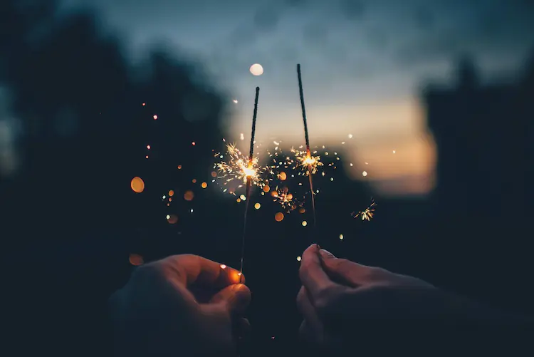 People lighting sparklers.